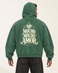AI-generated model wearing the green Walter Mercado Vintage-Wash Boxy Hoodie, showing the Mucho Mucho Amor back graphic